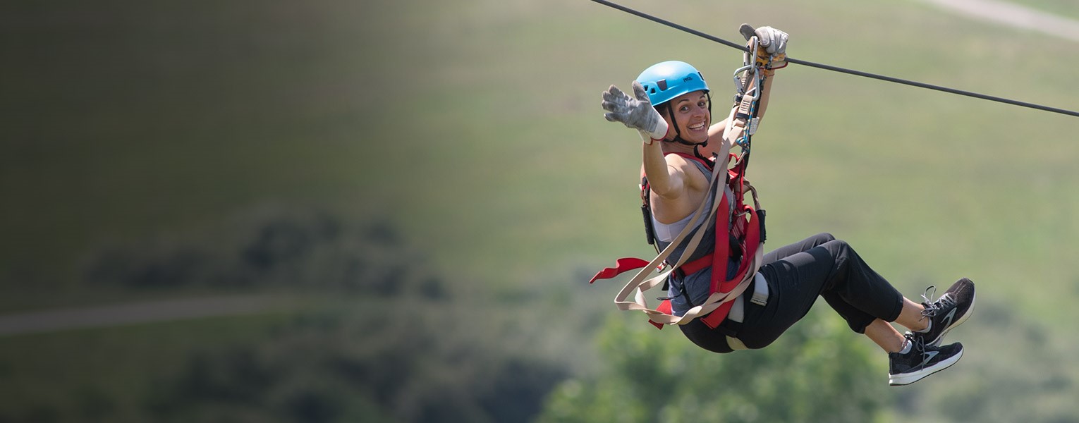woman ziplining at The Wilds