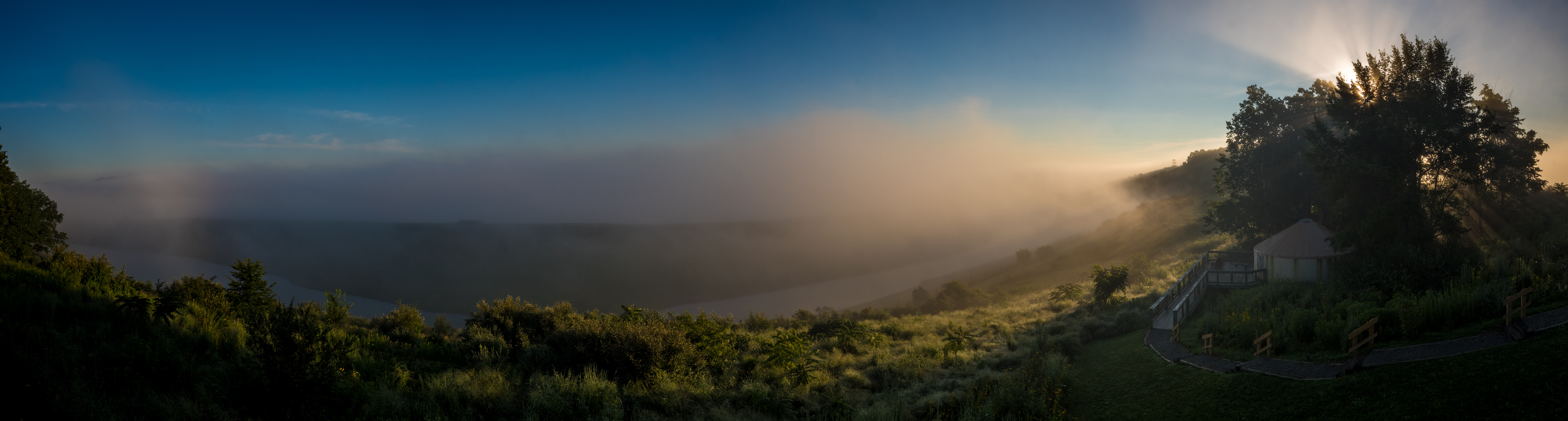 view of yurt on foggy hill