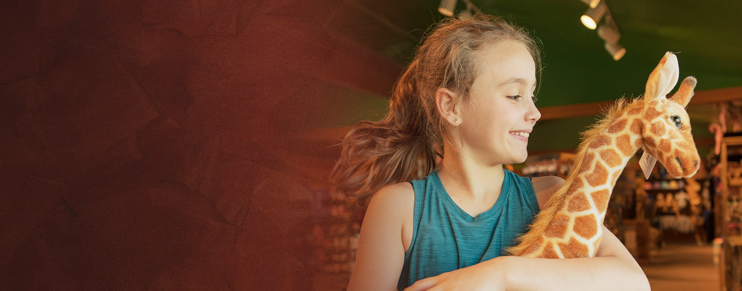 girl holding giraffe toy