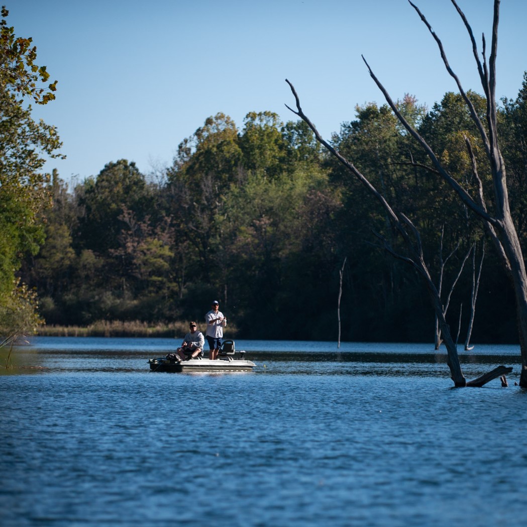 two men fishing in boat at The Wilds