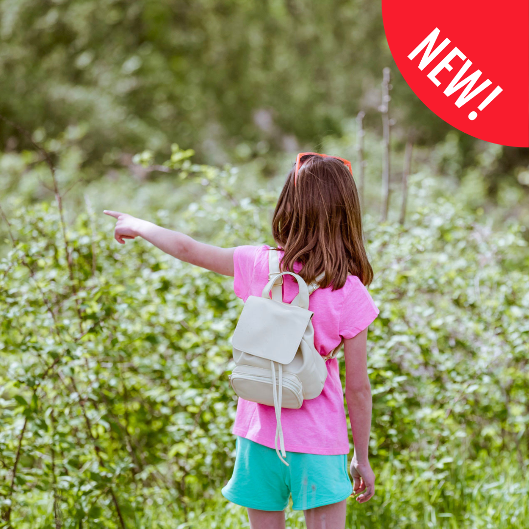 girl pointing at flower prairie at The Wilds