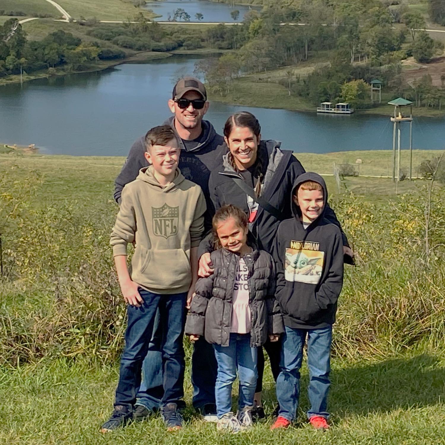 family standing in pasture