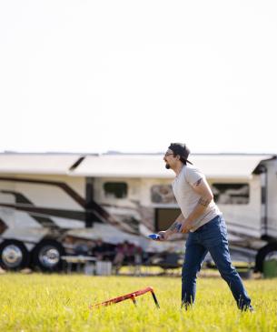man playing cornhole