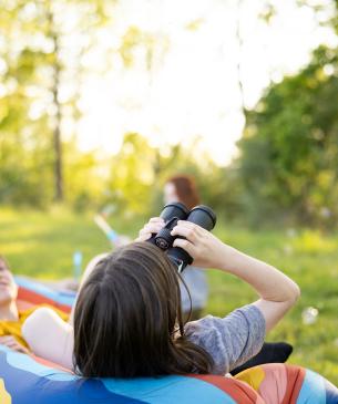 teenager looking through binoculars