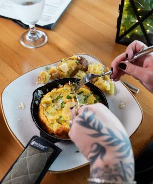 person eating quiche