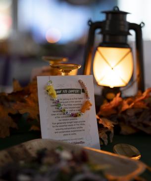 lantern and invitation on table at The Wilds