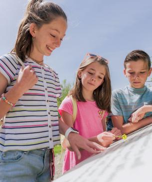 children reading outdoor sign