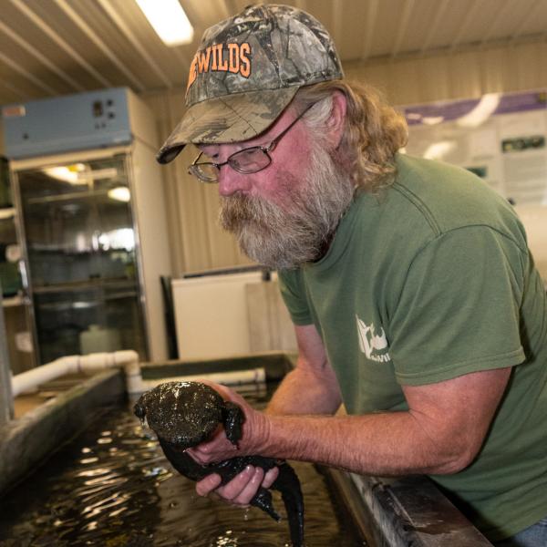 man holding hellbender