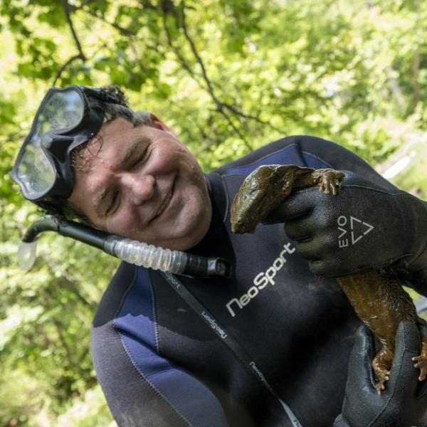scientist holding hellbender