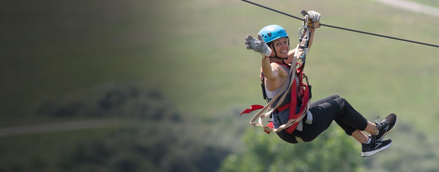 woman ziplining at The Wilds
